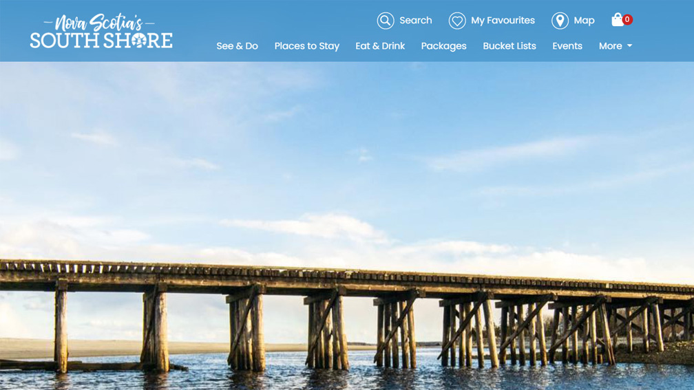A screenshot from the Visit South Shore website; below the navigation is an image of a wooden bridge over the water.