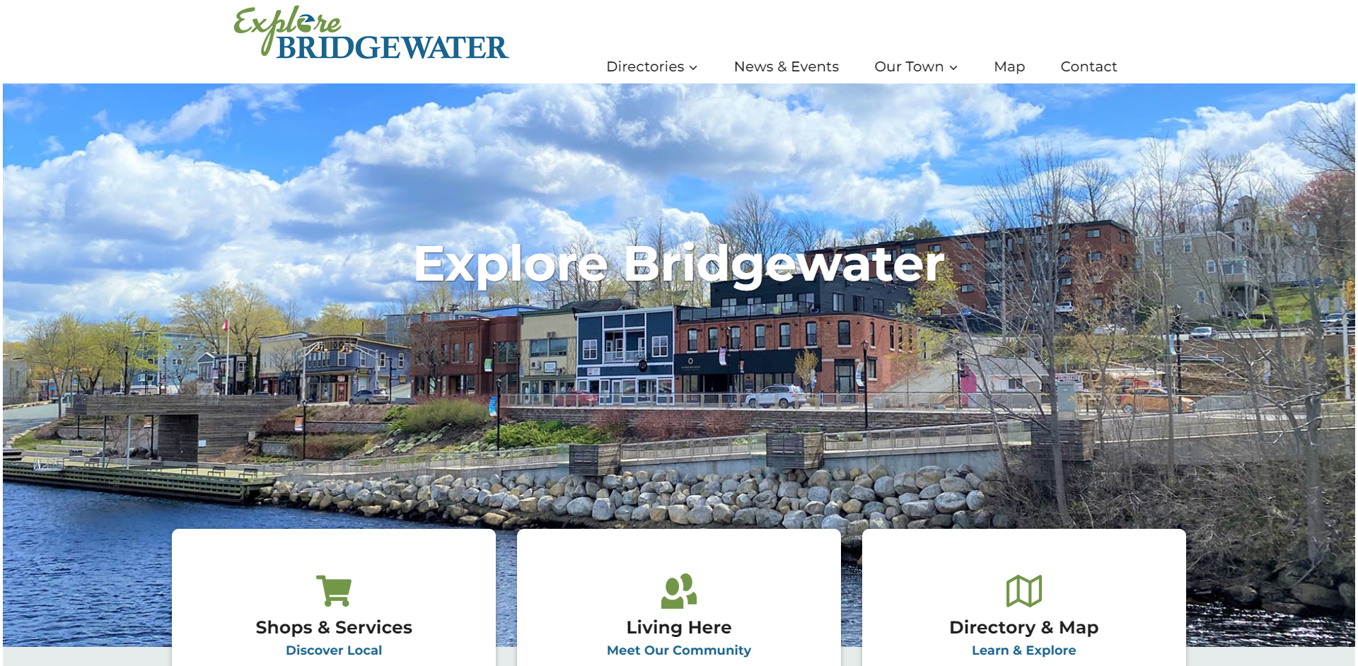A screenshot of the Explore Bridgewater homepage; below the navigation is an image of the downtown waterfront, showing a row of buildings along a stone-lined river.